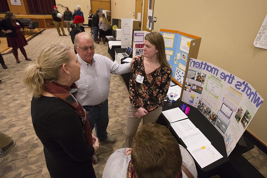 A student displays their lesson plan on a board.